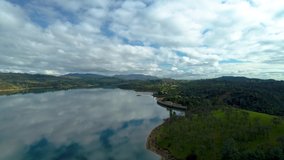 Drone aerial footage of reservoir lake and arch dam for renewable energy power plant in Switzerland Alps, top down view. 4K video
