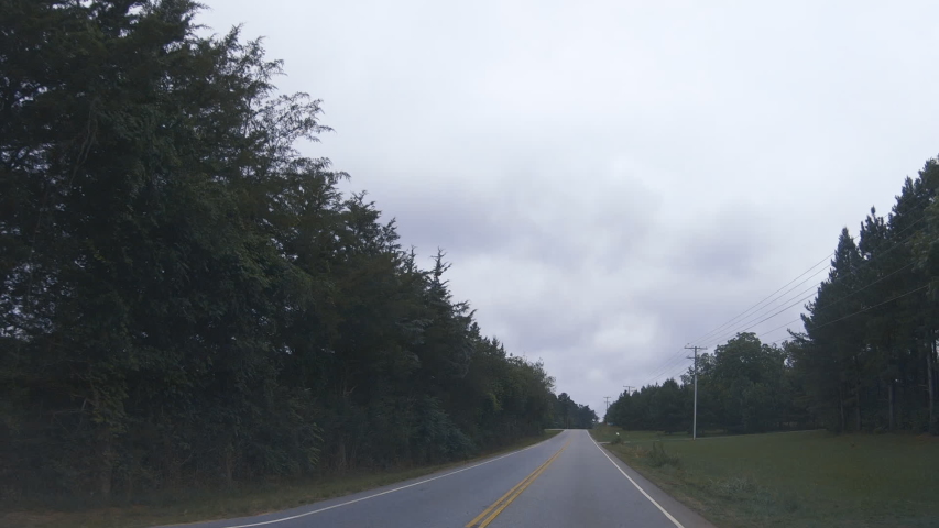 Drive Plate-Driving rural South Carolina on long straight stretch of two lane Oakway Highway state road 24 on a gray overcast day