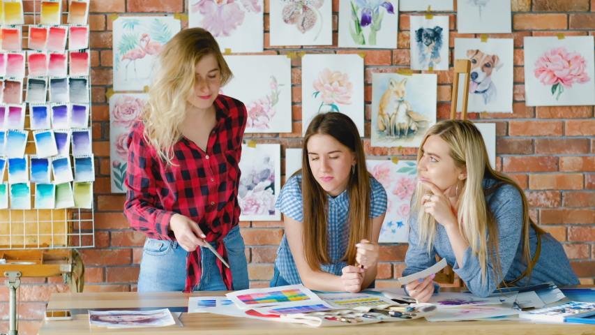 Art students in creative studion learning painting tricks and coloristics.