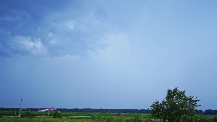 Bright lightning on the sky. Realistic view of direct lightning from sky to the ground in rural place. Dangerous time.