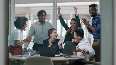 group of business people celebrating success watching laptop screen happy colleagues applause enjoying successful corporate victory achievement in modern office 4k