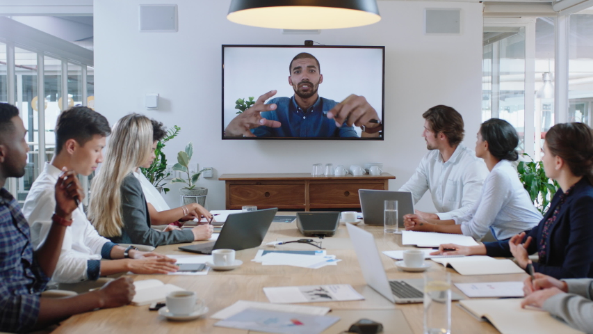 group of business people having conference call meeting in boardroom team leader man chatting to colleagues using online video chat on tv screen discussing ideas in office 4k Royalty-Free Stock Footage #1033254908