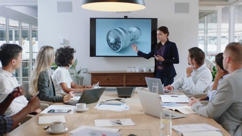business people meeting in boardroom engineer woman presenting turbine design on tv screen sharing technical briefing with colleagues discussing ideas in office presentation