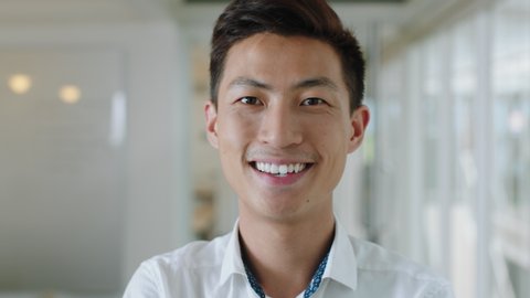 portrait young asian businessman smiling enjoying successful career proud entrepreneur in office workplace testimonial 4k footage