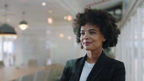 portrait successful business woman smiling confident with arms crossed enjoying corporate leadership young female executive planning ahead for positive future in office 4k footage