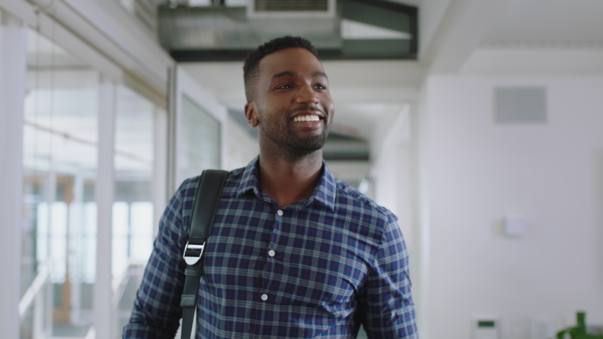 happy african american businessman walking through office arriving at work smiling confident enjoying first day at new job 4k Royalty-Free Stock Footage #1033257194