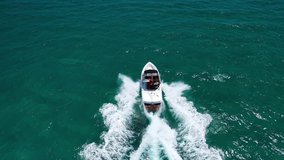 Aerial drone tracking video of speed boat cruising in high speed