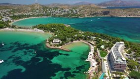 Aerial drone video of iconic turquoise sandy celebrity beach of Asteras or Astir, Vouliagmeni, Athens riviera, Attica, Greece