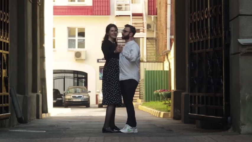 beautiful young woman and handsome man  dancing together on the street,  talking and laughing,  Love story. Romantic, cute, funny moments. Amazing scenery