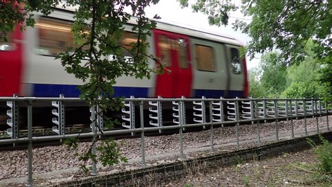 Chorleywood, Hertfordshire, England, UK - July 12th 2019: London Underground S8 train passing by on the Metropolitan line