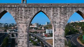 Drone video made by flying through arch of ancient Portuguese aqueduct of Free Waters (Aqueduto das Aguas Livres) in Alcantara, Portugal 