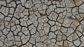 Desert. Aerial view of a beautiful cracks in the ground. texture, deep crack. Effects of heat and drought. effects of global warming. cracked desert landscape (no color grading video)