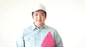Smiling Asian delivery man in uniform.