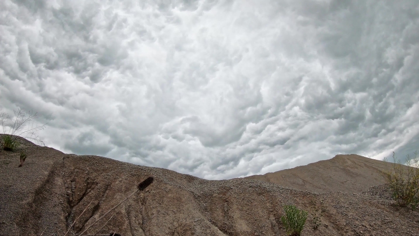 Ominous rolling storm clouds motion time lapse over quarry in central Kentucky 