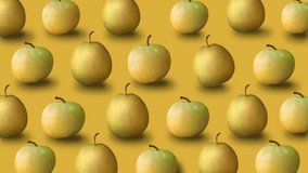 Colorful fruit pattern of fresh yellow apples and pears on green background. 4k video.