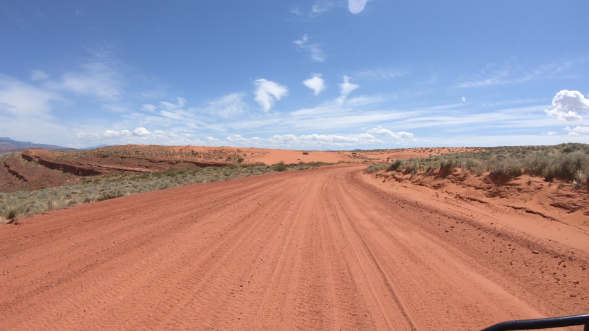 Off road ATV drive desert road POV Southern Utah. Southern Utah desert Sand Hollow. Red sandstone, dirt sand trails. Outdoor extreme 4x4 recreation ride and adventure. Point of view, POV. Royalty-Free Stock Footage #1033289243