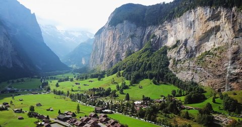 Aerial Pan Left to Right: Mountain Cliff With Waterfalls in Lauterbrunnen