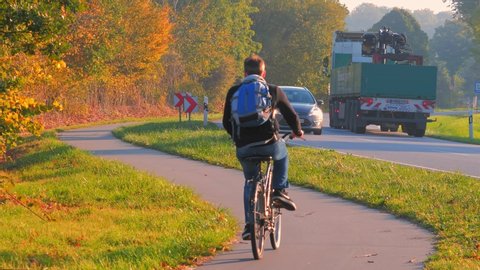 LUBECK, GERMANY - OCTOBER 11, 2018: Bike road and car route, Driving on country road