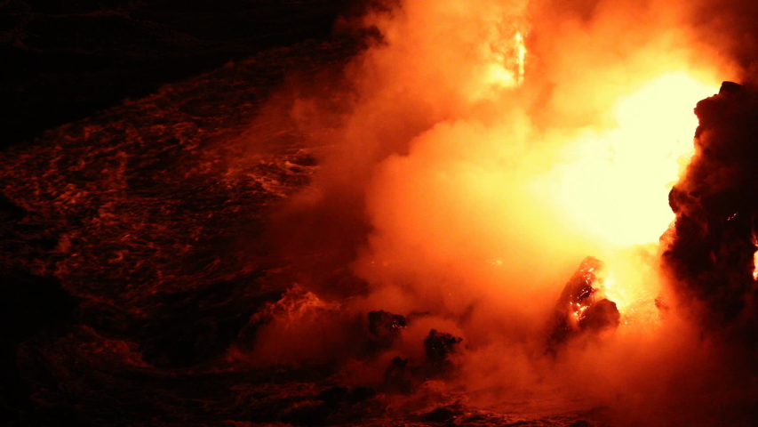 Lava flowing into the ocean from volcano lava eruption on Big Island Hawaii. Lava stream flowing in Pacific Ocean from Kilauea volcano around Hawaii volcanoes national park, USA. Night shot 59.94 FPS. Royalty-Free Stock Footage #1033310084
