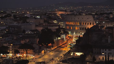 rome skyline illuminated at night from high pov,view of colosseum and via dei fori imperiali