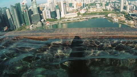Water Pool On Roof Of Skyscraper. Glittering Water Surface. View Of City. Singapore. Southeast Asia.