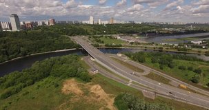 4K aerial summer late afternoon high quality video footage of new road highway, Grebnoi rowing water sports channel, cloudy sky in suburb Krilatskoye, Moscow River watercourse in Moscow, Russia