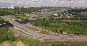 4K aerial summer late afternoon high quality video footage of new road highway, Grebnoi rowing water sports channel, cloudy sky in suburb Krilatskoye, Moscow River watercourse in Moscow, Russia