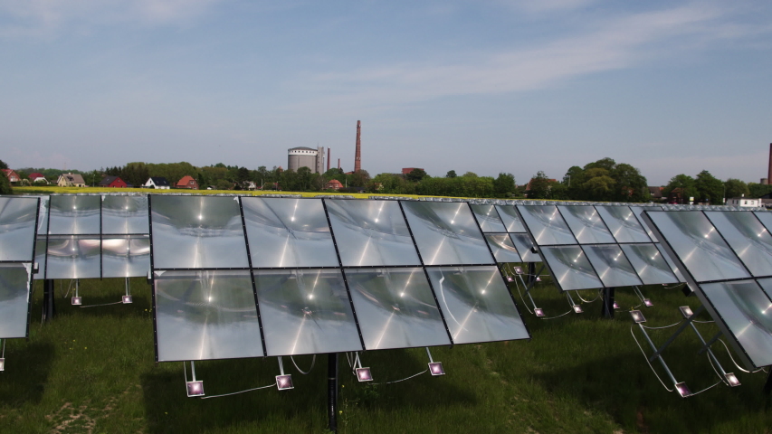 Solar panel i fron of green city - scene from drone