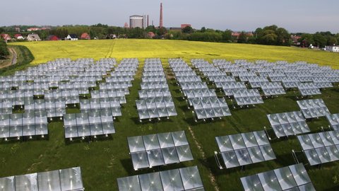 Flying slowly over solar panel towards green city in Denmark