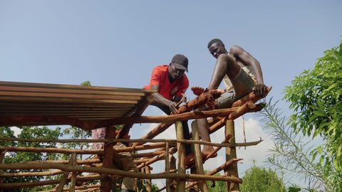 Jinja, Jinja District / Uganda - 01 08 2019: Jinja, Uganda January 2019 - A group of Ugandans build a mud house in a rural village.