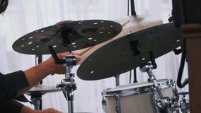 Slow motion shot of a musician performing on drums on festival