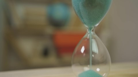 Sand grains in the hourglass. Shallow depth of field. Time is money concept.