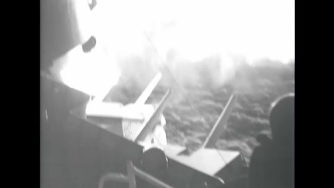 CIRCA 1944 - The USS Missouri fires its guns at dusk.