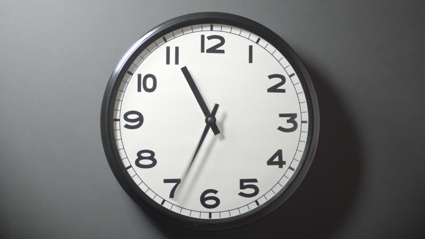 Closeup of White Clock Face in timelapse in daytime of office dark grey wall
 | Shutterstock HD Video #1033388942