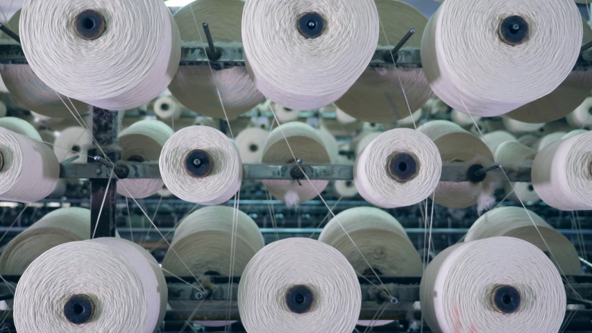 Tailoring loom with rotating sewing reels. Textile factory equipment. | Shutterstock HD Video #1033390142