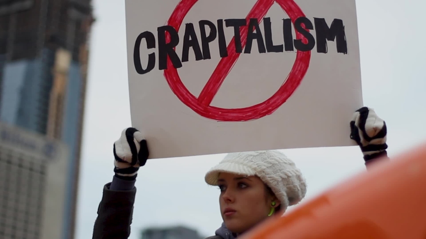 Toronto, Canada - 02 01 2019: Woman Holds Crapitalism Banner At Protest Occupy Wallstreet Toronto