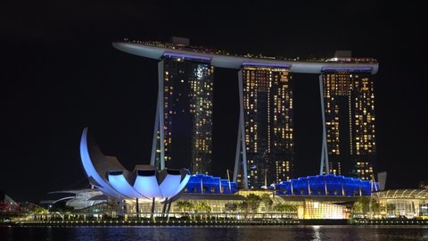 SINGAPORE CITY, SINGAPORE - MARCH 29, 2019: Marina Bay Sands is an integrated resort fronting Marina Bay at night view, establishing shot