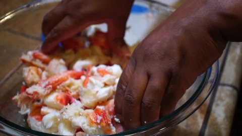 Mixing juicy fresh crab meat by hand in bowl, Slowmo Close Up
