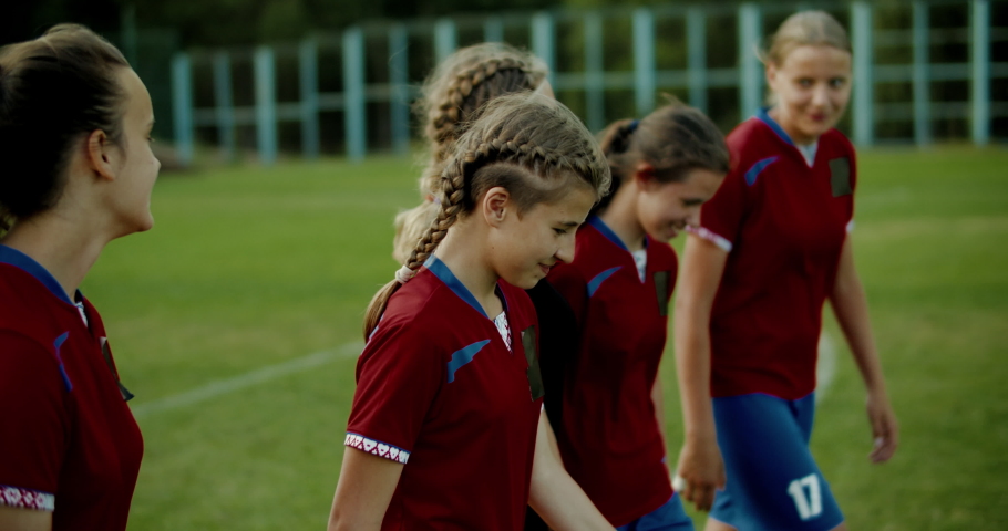 TRACKING Teenager kid girls soccer players talking and laughing after training. 4K UHD 60 FPS SLO MO Royalty-Free Stock Footage #1033416299