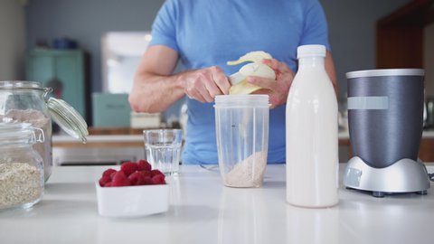 Close Up Of Man Making Protein Shake After Exercise At Home