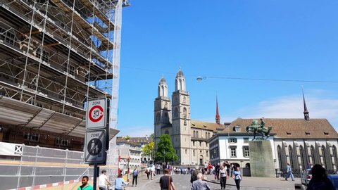 Zürich, Switzerland - 06 18 2018: Hyperlapse tracking shot of Grossmunster church with tourists in Zürich Switzerland