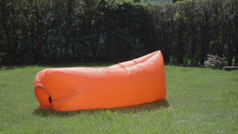 Funny summer fail video as a woman falls off of an inflatable couch in her backyard