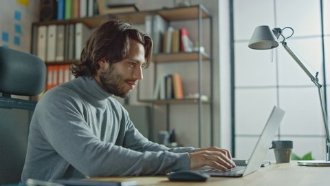 Handsome Long Haired Hispanic Businessman Sitting at His Desk in the Office Works on a Laptop. Creative Developing New Software Unicorn Startup Project, Finalizing Business Transaction