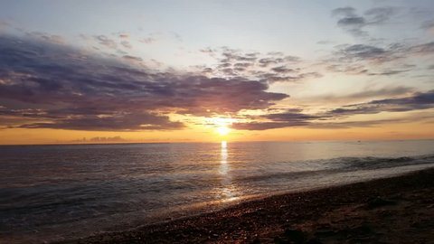 Beautiful multicolored sunset over sea. Sunny path reflecting the sunset in the Baltic sea. Timelapse. No sound.