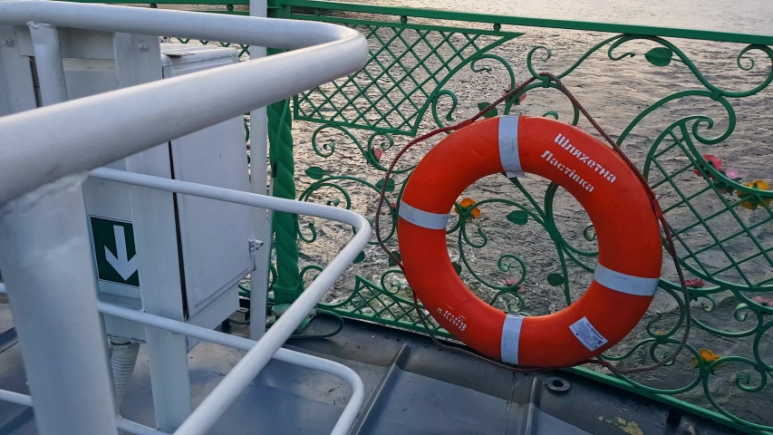 4K, the ship sails on the wide river of the Dnieper with large bridges before the sunset