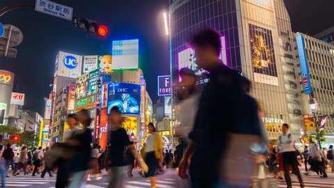 Shibuya, Tokyo - JUNE 08, 2018 : Shibuya district at night with crowd passing crosswalk. Tokyo, Japan. 4K Timelapse