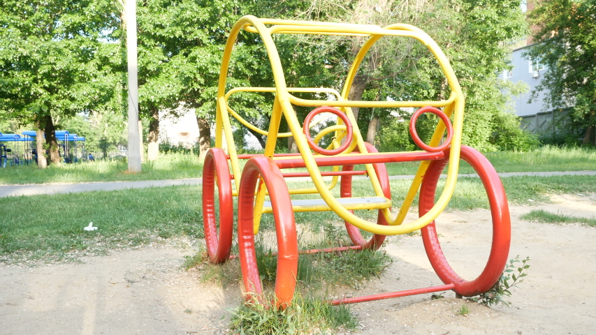 Boy and car.
Guy sits in car in the yard of the child garden and grimaces portraying driving a car.