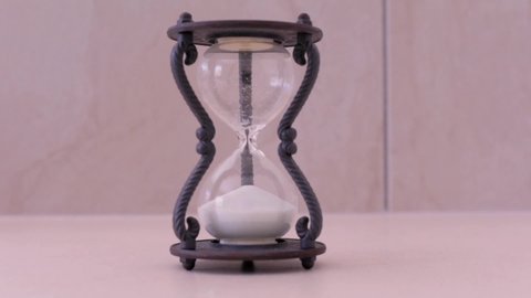 Time-lapse hourglass in reverse with sand going upwards  (turn back time)