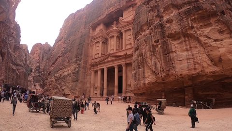Petra, Jordan November 13 2019: View of Petra treasury square with crowd of tourists and local Bedouins offering their services.