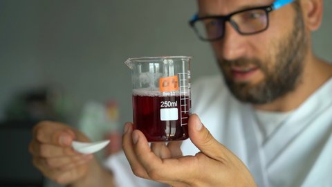 Man scientist doing lab test with chemicals